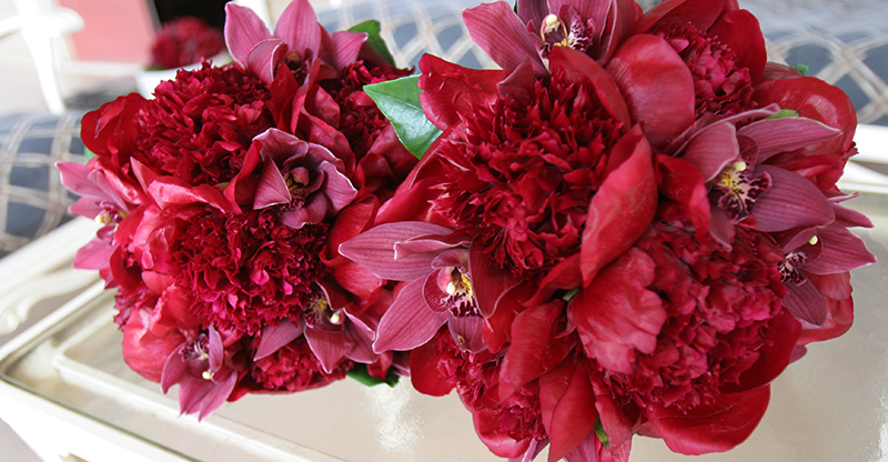 red peonies in brides bouquet